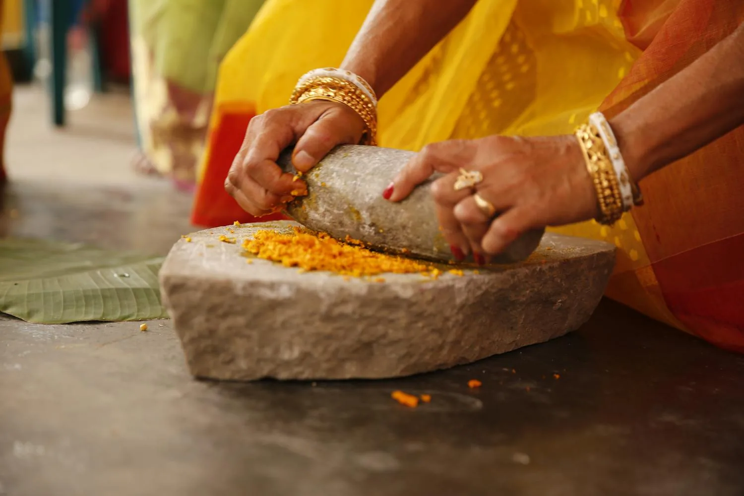 Stone-grinding the dried fruit into powder
